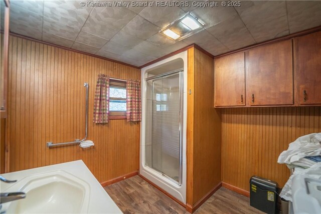 356 Joes Rd, Bomont, WV 25164 - bathroom with baseboards, wood finished floors, a sink, and a shower stall