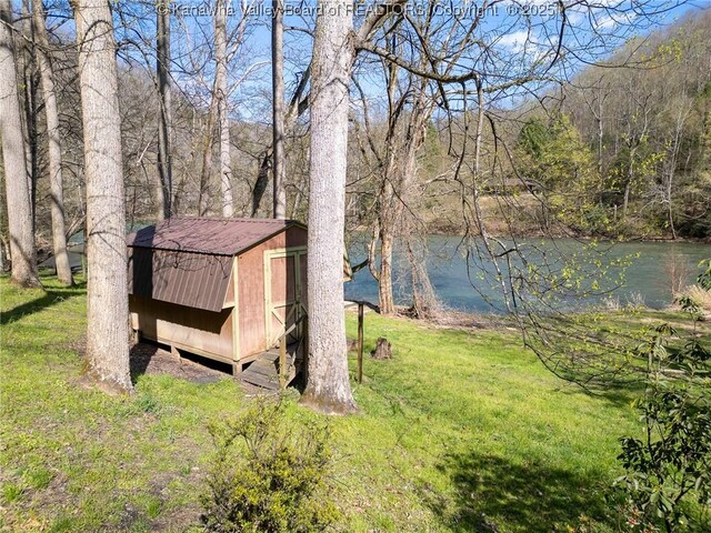 356 Joes Rd, Bomont, WV 25164 - view of yard with a forest view, an outbuilding, a storage shed, and a water view