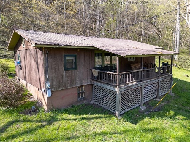356 Joes Rd, Bomont, WV 25164 - back of house featuring a lawn, a wooded view, and metal roof