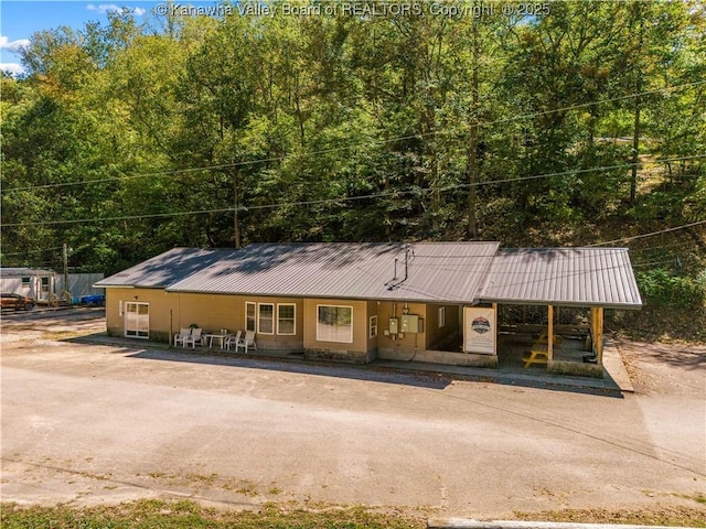view of front of home with covered porch and metal roof