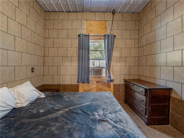 tiled bedroom featuring tile walls and cooling unit
