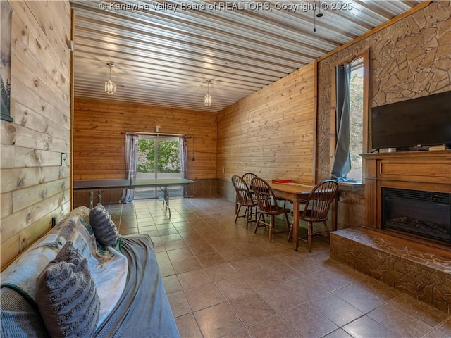 interior space with wood walls and a glass covered fireplace