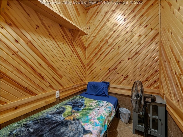 bedroom featuring wood walls
