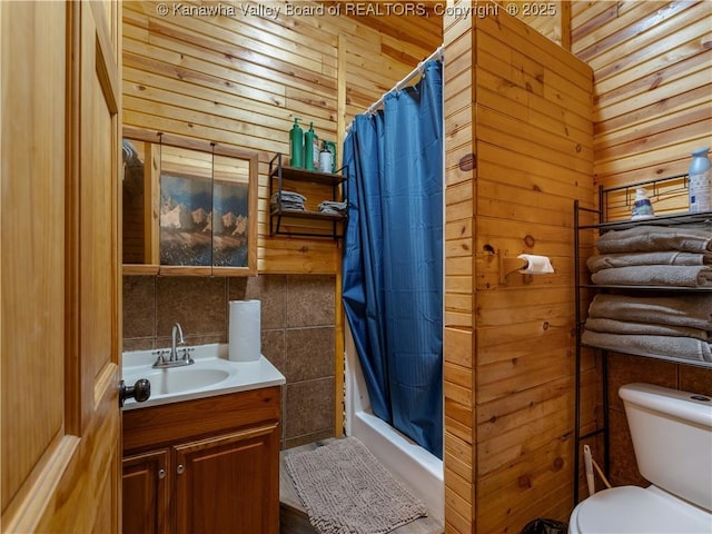 bathroom featuring toilet, wood walls, a shower with curtain, and vanity