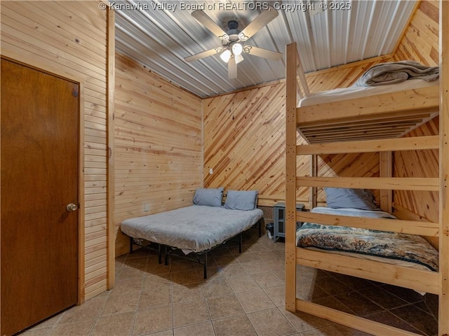 tiled bedroom with wooden walls and a ceiling fan