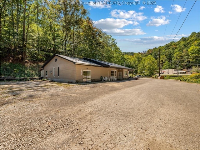 view of home's exterior featuring a wooded view