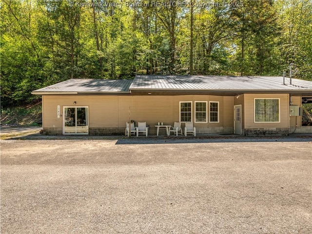back of house with metal roof
