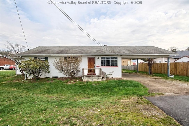455 Kane St, Milton, WV 25541 - view of front facade featuring fence, a carport, aphalt driveway, and a front yard
