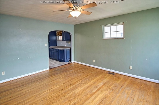455 Kane St, Milton, WV 25541 - spare room with light wood finished floors, visible vents, arched walkways, baseboards, and ceiling fan