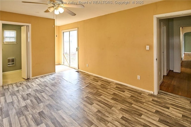 455 Kane St, Milton, WV 25541 - unfurnished room with wood finished floors, a healthy amount of sunlight, ceiling fan, and heating unit