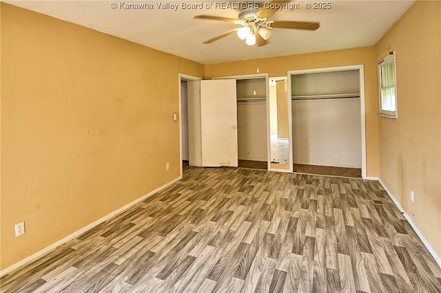 455 Kane St, Milton, WV 25541 - unfurnished bedroom featuring baseboards, wood finished floors, two closets, and ceiling fan