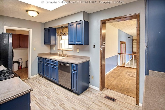 455 Kane St, Milton, WV 25541 - kitchen featuring a sink, a textured ceiling, freestanding refrigerator, dishwashing machine, and blue cabinetry