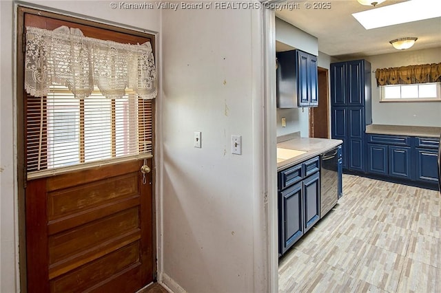 455 Kane St, Milton, WV 25541 - kitchen with blue cabinets, light countertops, baseboards, a skylight, and dishwasher