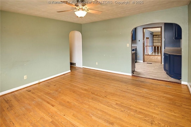 455 Kane St, Milton, WV 25541 - unfurnished room with arched walkways, a ceiling fan, light wood-type flooring, and baseboards