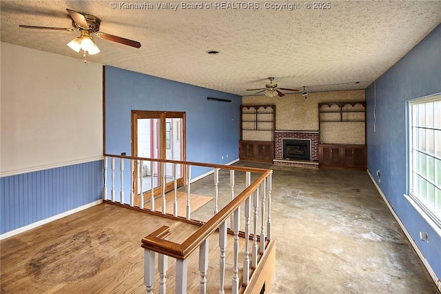 455 Kane St, Milton, WV 25541 - interior space with ceiling fan, a brick fireplace, a textured ceiling, and plenty of natural light