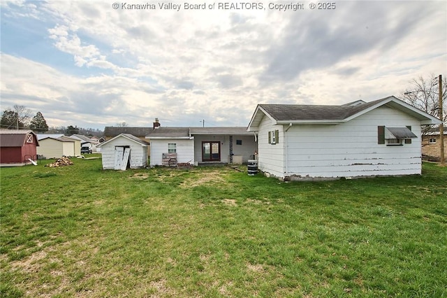 455 Kane St, Milton, WV 25541 - back of property featuring an outdoor structure, a storage unit, and a lawn