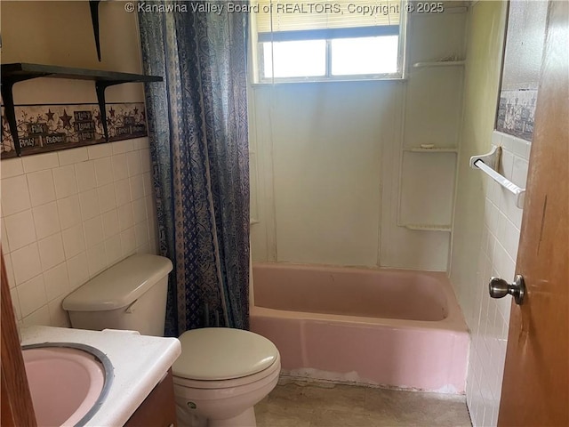 full bath with tile walls, toilet, vanity, and shower / bathtub combination with curtain