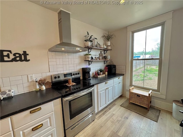 2206 Jefferson Ave, Point Pleasant, WV 25550 - kitchen with dark countertops, a healthy amount of sunlight, stainless steel range with electric stovetop, and wall chimney range hood