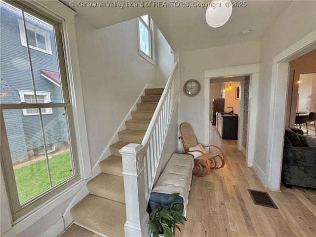 2206 Jefferson Ave, Point Pleasant, WV 25550 - stairs featuring baseboards, hardwood / wood-style floors, and visible vents