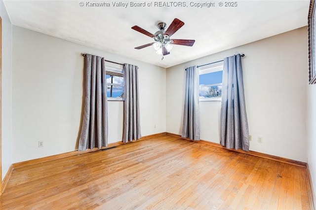unfurnished room featuring baseboards, hardwood / wood-style flooring, and ceiling fan