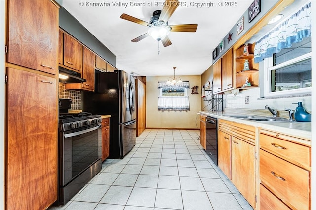 kitchen featuring a sink, black dishwasher, gas range oven, decorative backsplash, and under cabinet range hood