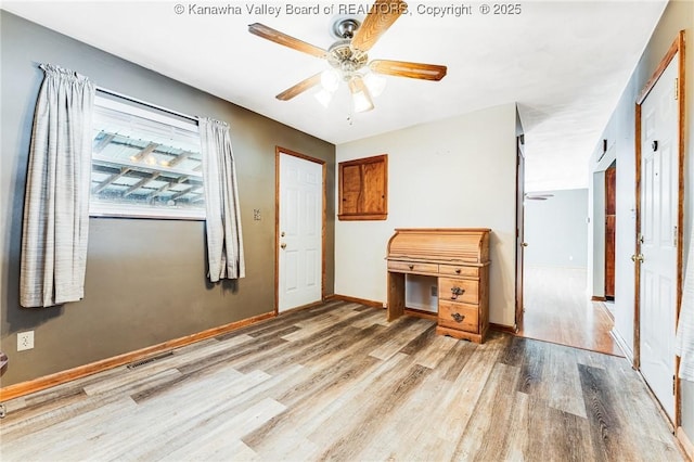 unfurnished bedroom featuring ceiling fan, baseboards, wood finished floors, and visible vents
