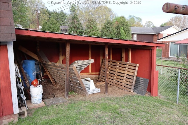 view of outbuilding featuring fence