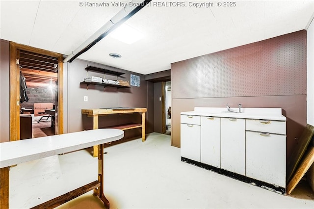 interior space with concrete flooring and a sink