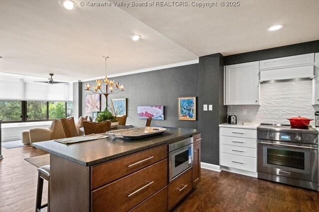 1578 Kanawha Blvd Unit 7C, Charleston, WV 25311 - kitchen with stainless steel appliances, dark wood-style flooring, backsplash, white cabinets, and recessed lighting