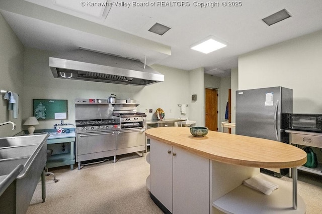 1578 Kanawha Blvd Unit 7C, Charleston, WV 25311 - kitchen with wall chimney exhaust hood, open shelves, stainless steel range with gas stovetop, butcher block countertops, and oven