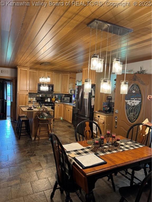 12376 Elk River Rd N, Clendenin, WV 25045 - dining space featuring wooden ceiling, stone tile flooring, and a chandelier