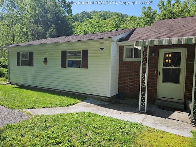 12376 Elk River Rd N, Clendenin, WV 25045 - view of front of home with a front lawn, brick siding, and roof with shingles