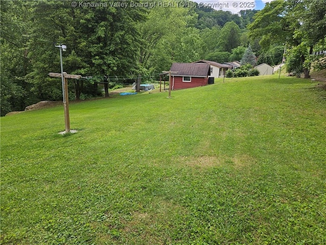 12376 Elk River Rd N, Clendenin, WV 25045 - view of grassy yard featuring an outbuilding and a wooded view