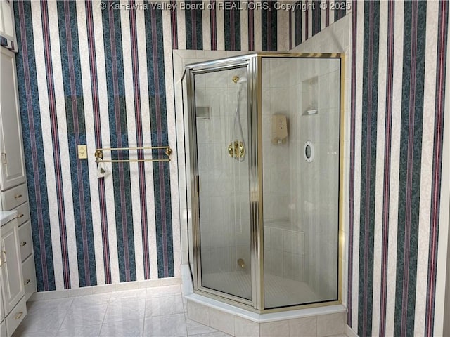 207 Mckinley Ave, Charleston, WV 25314 - bathroom with baseboards, tile patterned flooring, a stall shower, and wallpapered walls