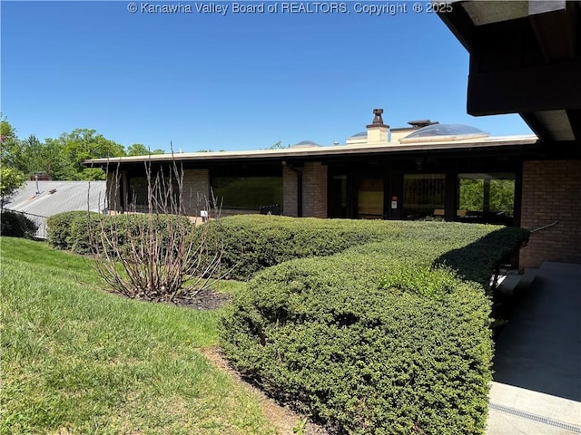 207 Mckinley Ave, Charleston, WV 25314 - back of house featuring brick siding and a chimney