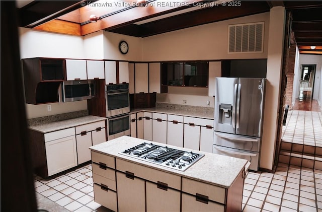 207 Mckinley Ave, Charleston, WV 25314 - kitchen with stainless steel appliances, visible vents, light tile patterned flooring, and a center island