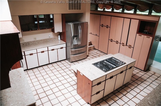 207 Mckinley Ave, Charleston, WV 25314 - kitchen featuring a kitchen island, stainless steel appliances, visible vents, and light tile patterned floors