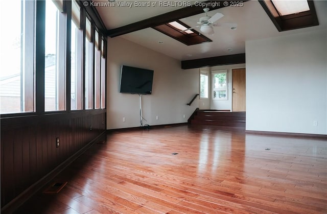 207 Mckinley Ave, Charleston, WV 25314 - spare room with vaulted ceiling with skylight, light wood-style floors, stairs, a ceiling fan, and baseboards
