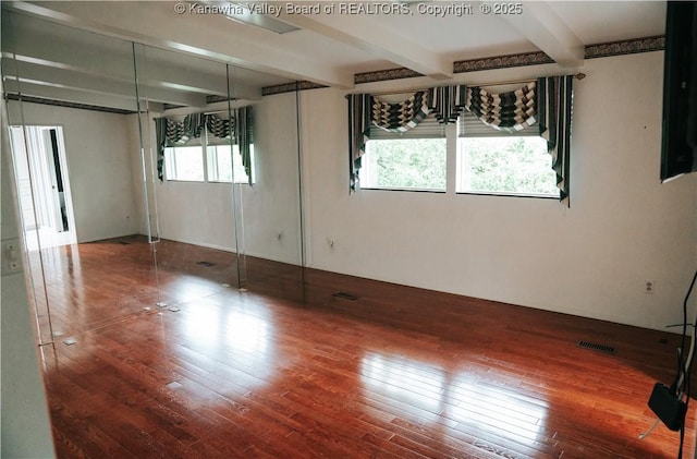 207 Mckinley Ave, Charleston, WV 25314 - spare room featuring wood-type flooring, beam ceiling, and visible vents