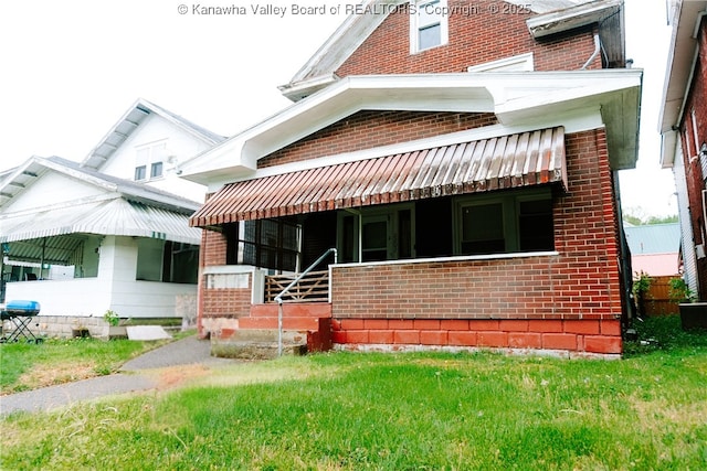 view of front of home featuring brick siding