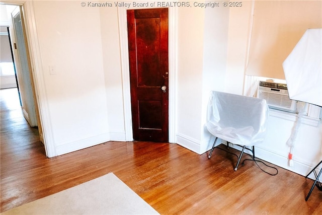interior space with wood finished floors and baseboards