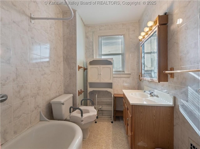54 Hunt Ave, Charleston, WV 25302 - bathroom featuring tile walls, vanity, a bathtub, toilet, and a bidet