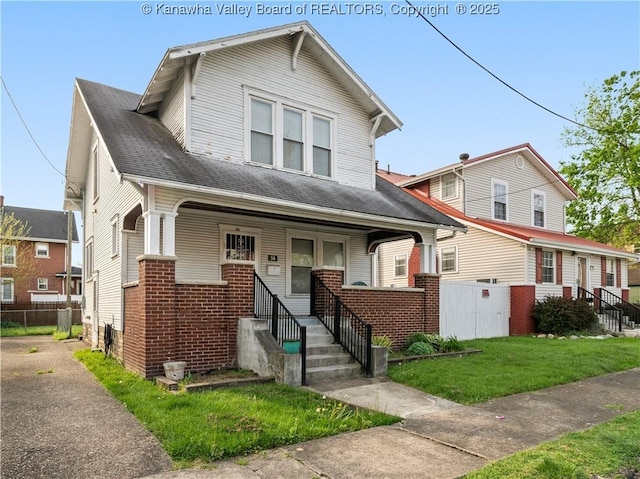 54 Hunt Ave, Charleston, WV 25302 - view of front of home with a porch, a front yard, brick siding, and fence