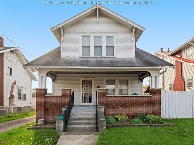 54 Hunt Ave, Charleston, WV 25302 - view of front of property with a porch, a front yard, brick siding, and fence