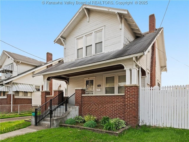54 Hunt Ave, Charleston, WV 25302 - view of front of house with a chimney, brick siding, fence, and covered porch