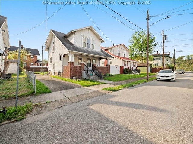 54 Hunt Ave, Charleston, WV 25302 - view of front facade featuring fence, central AC, and brick siding