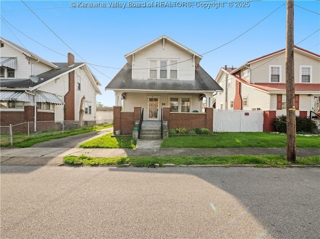 54 Hunt Ave, Charleston, WV 25302 - bungalow-style home with covered porch, brick siding, and fence
