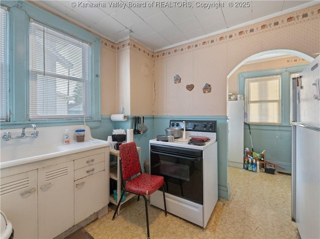 54 Hunt Ave, Charleston, WV 25302 - kitchen with light floors, white appliances, plenty of natural light, and wallpapered walls