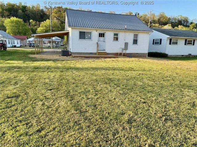 rear view of property featuring a yard, cooling unit, metal roof, and crawl space