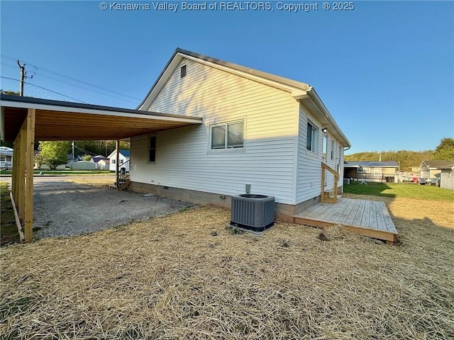 view of property exterior featuring crawl space, an attached carport, and central AC unit